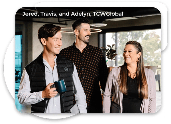 Three TCWGlobal workers standing and smiling at each other